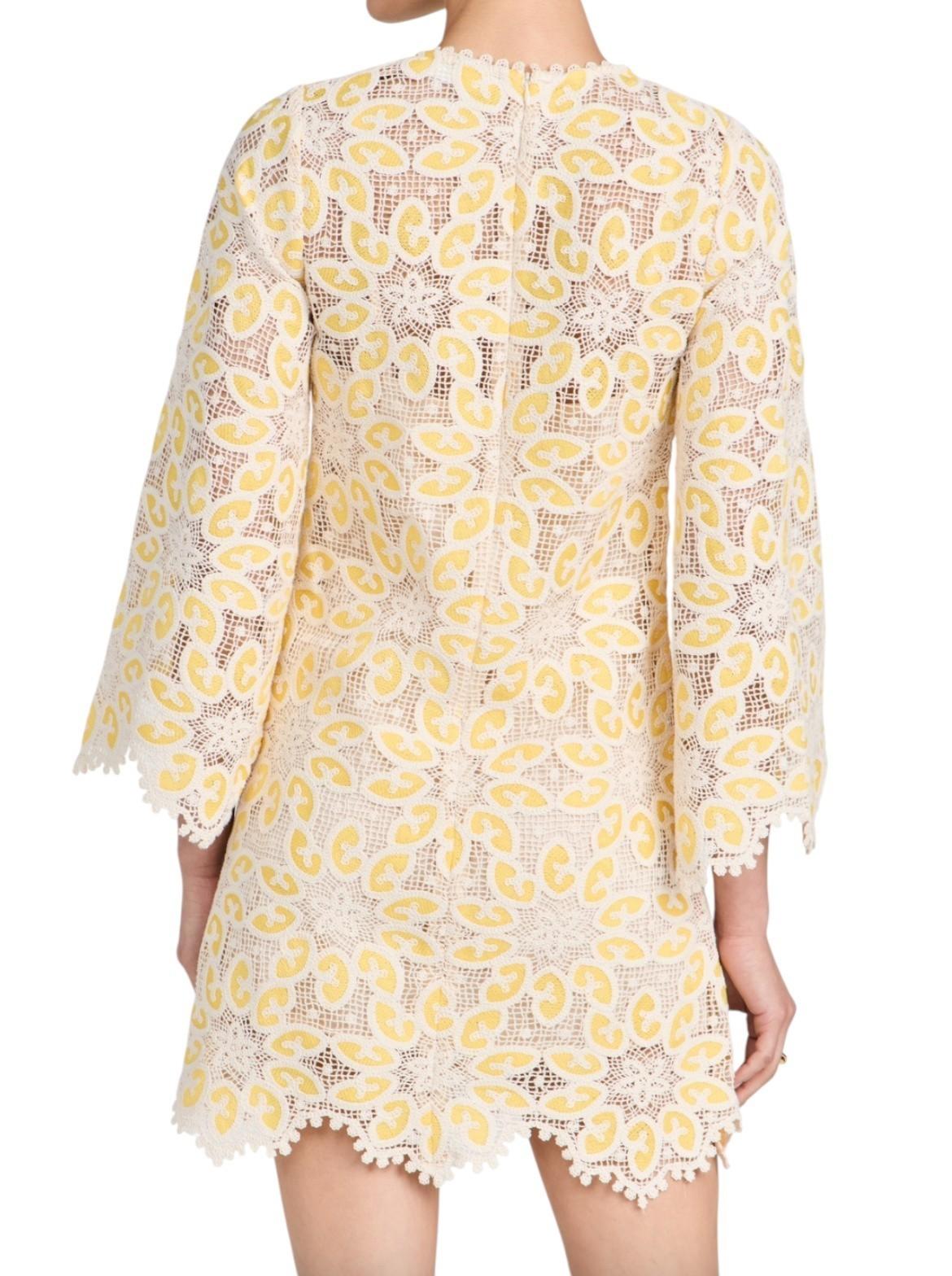 Yellow and white floral lace dress on a white background