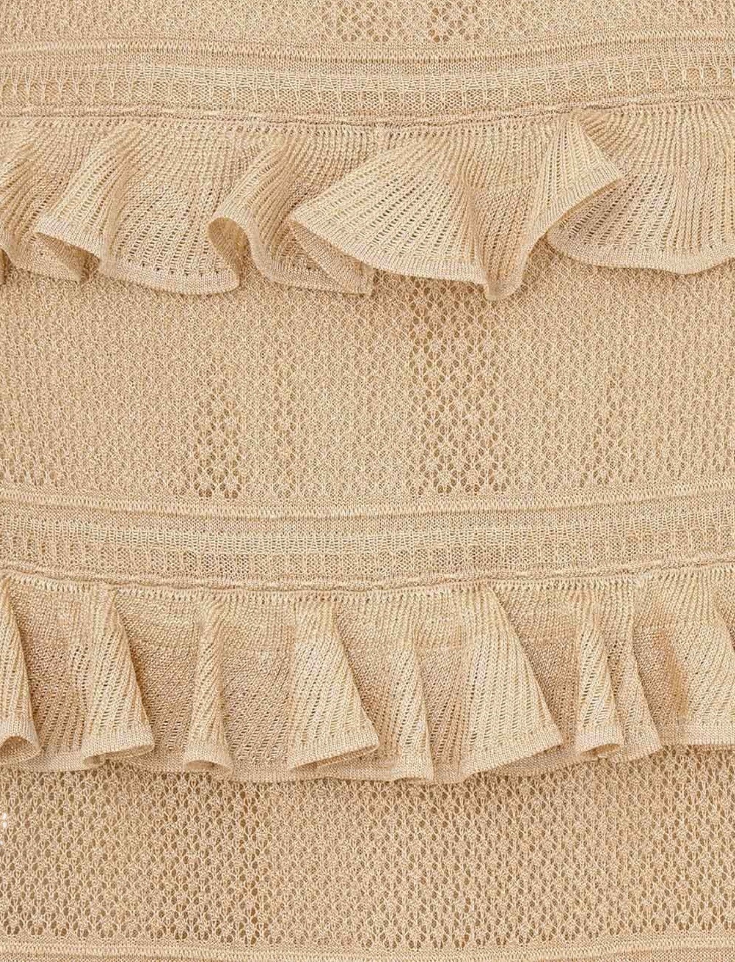 Close-up of beige textured fabric with ruffled edges