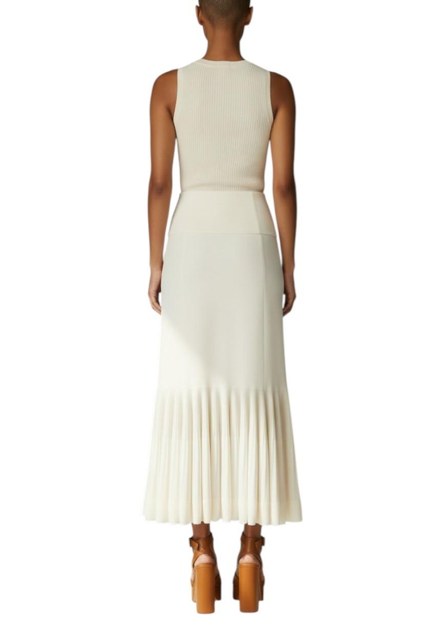 AI generated image of Woman wearing a white dress with pleated skirt on a white background