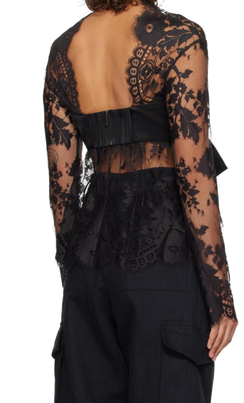 Black lace long-sleeve top with sheer design on a white background