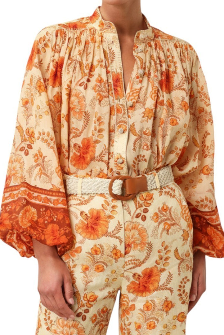 AI Generated image of Woman wearing a floral patterned outfit with orange and beige colors on a white background