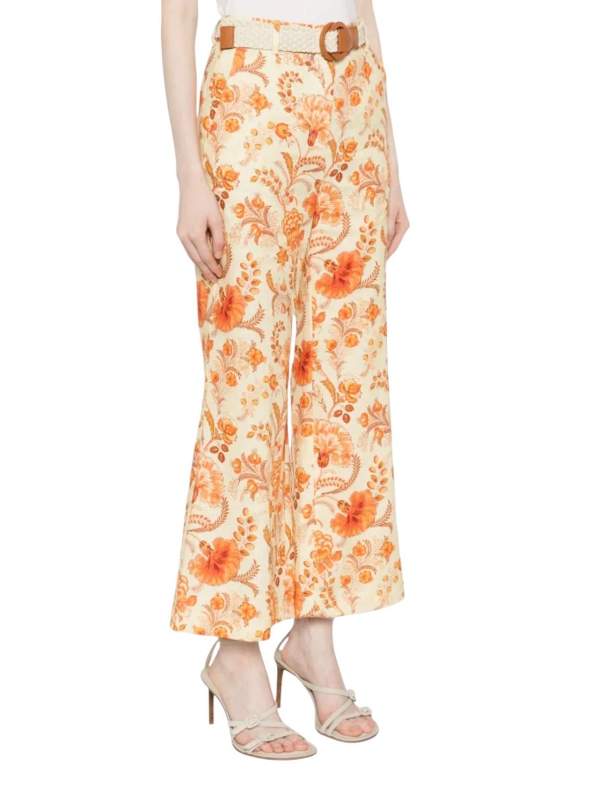 Floral patterned pants worn by a person on a white background