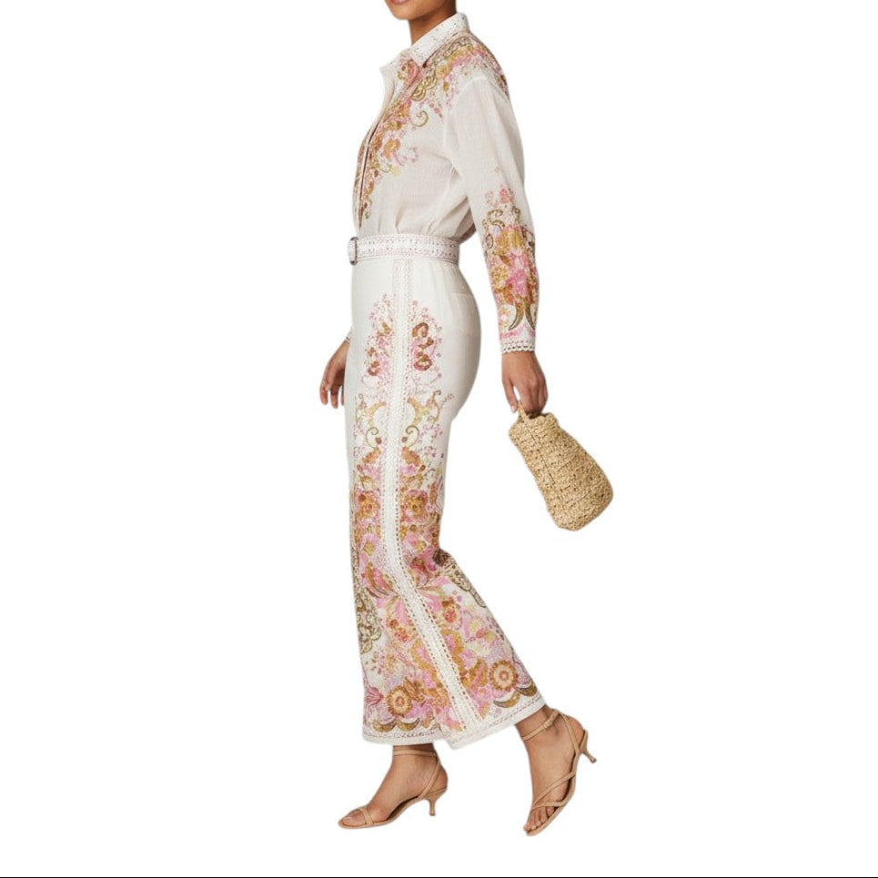 AI generated image of Woman wearing a white floral jumpsuit holding a straw bag on a white background