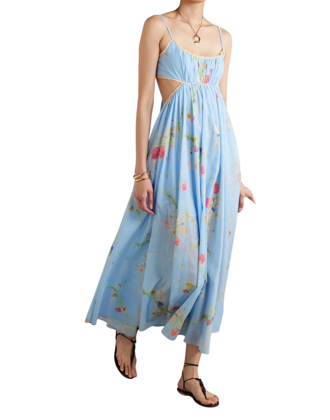 Woman wearing a light blue floral dress on a white background