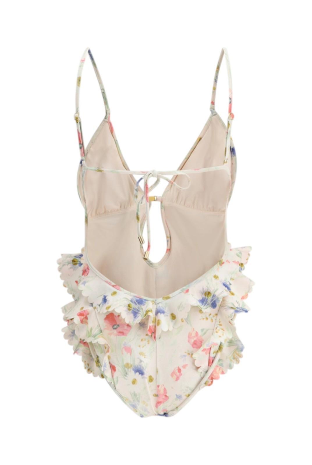 Beige swimsuit with floral ruffle bottom on a white background