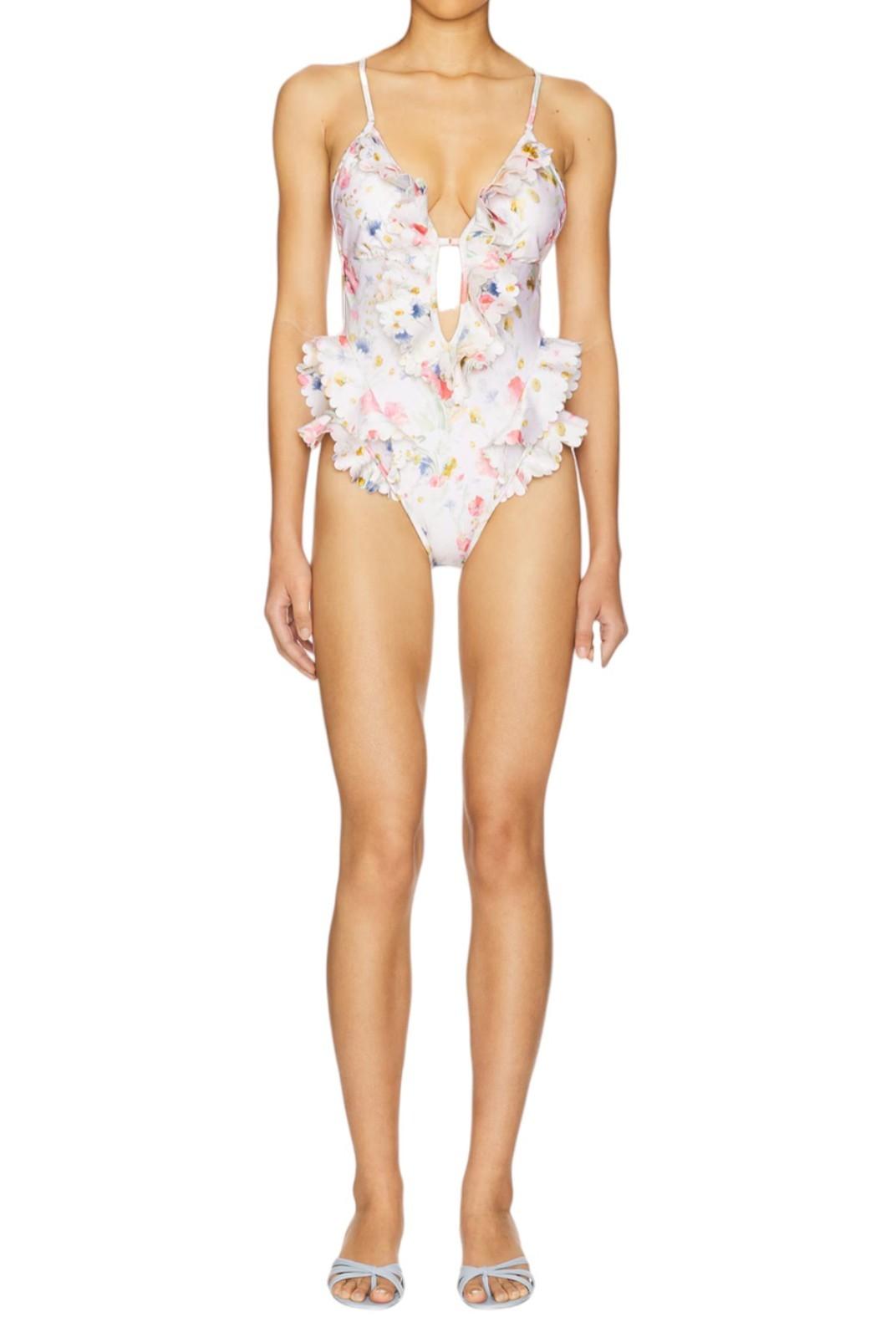 Woman wearing a floral one-piece swimsuit on a white background