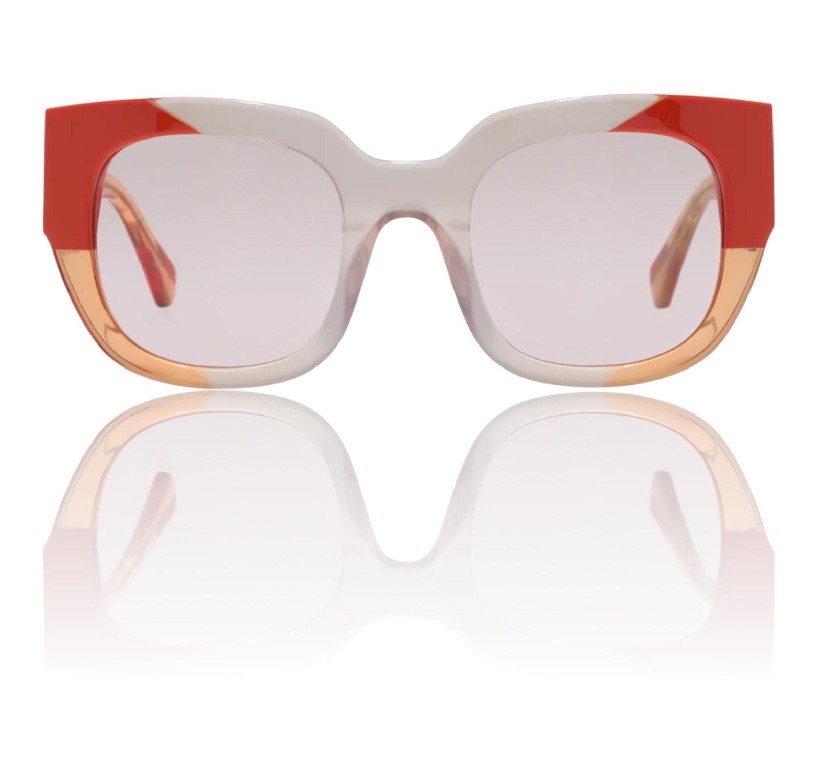 Sunglasses with red and beige frame on a white background