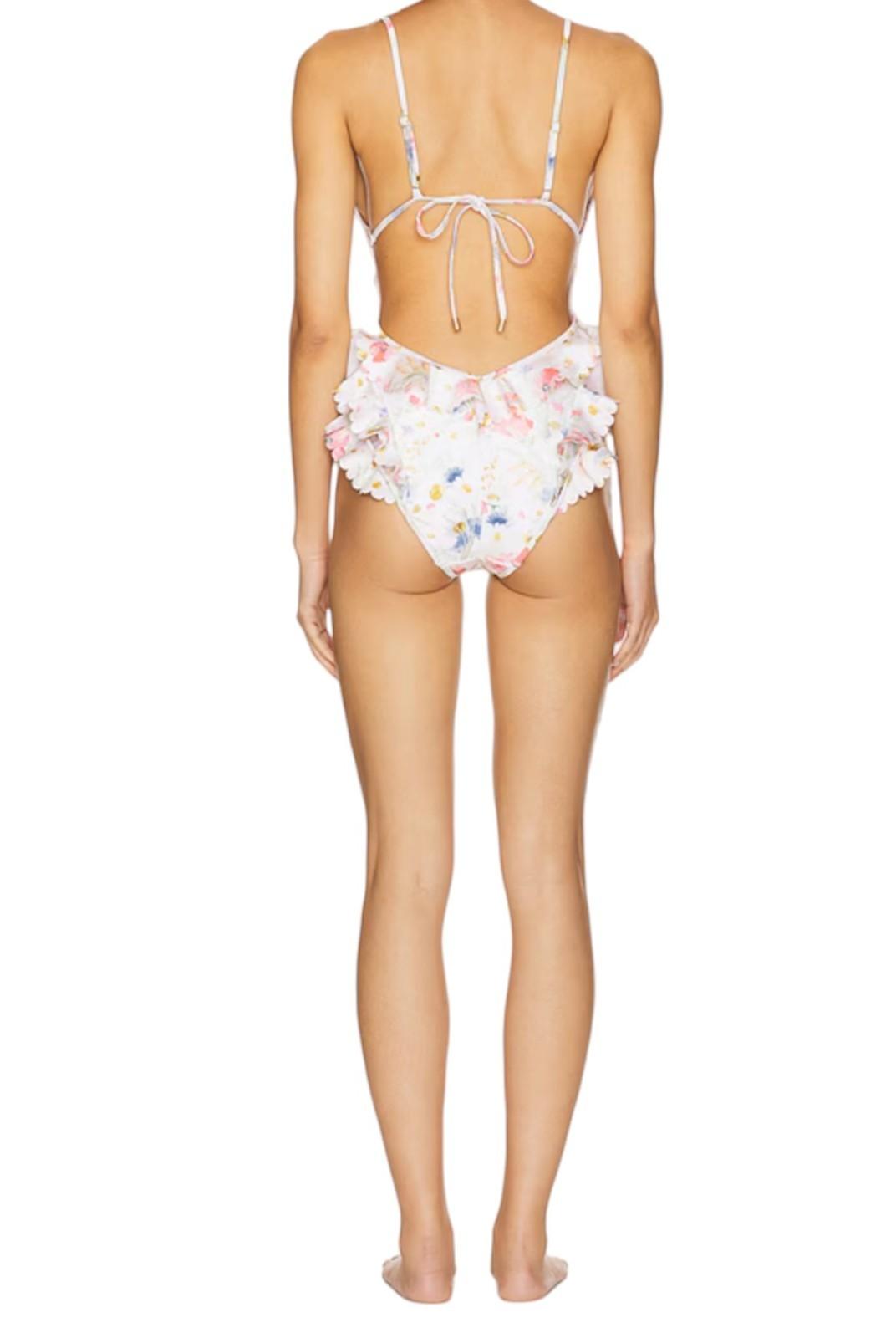 Woman wearing a floral bikini on a white background
