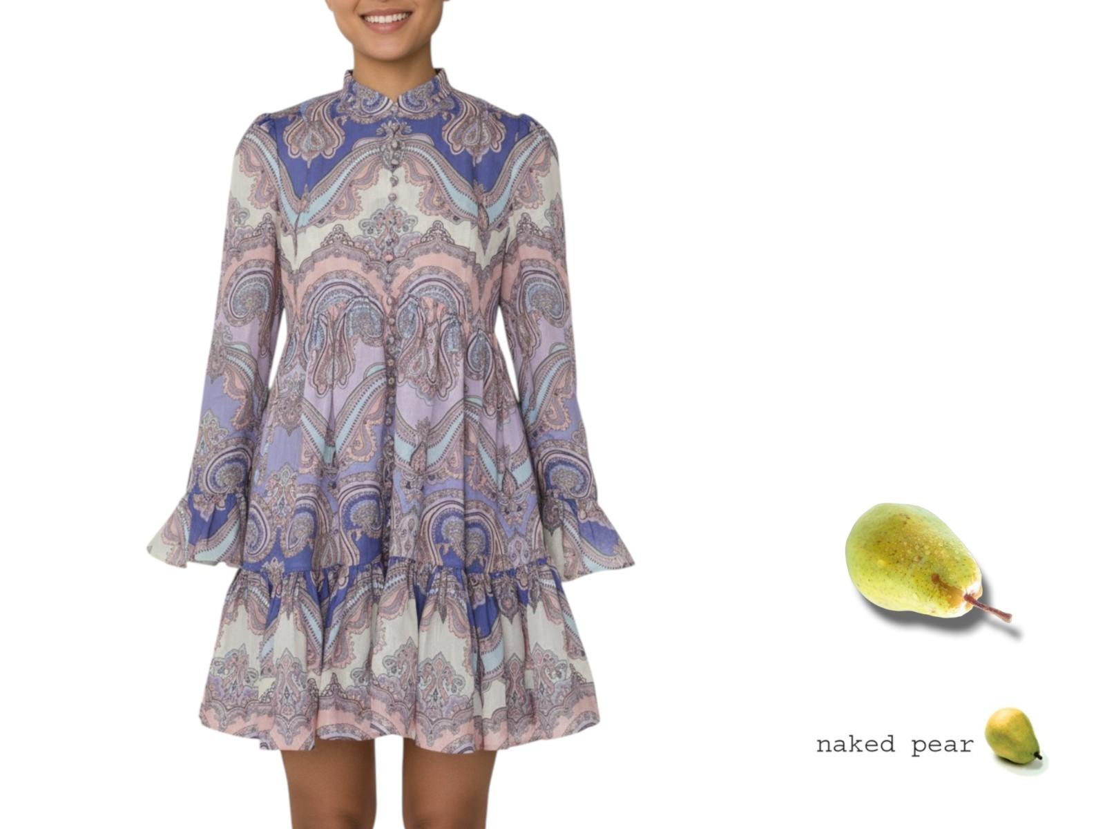 Woman wearing a patterned dress with a pear graphic on a white background