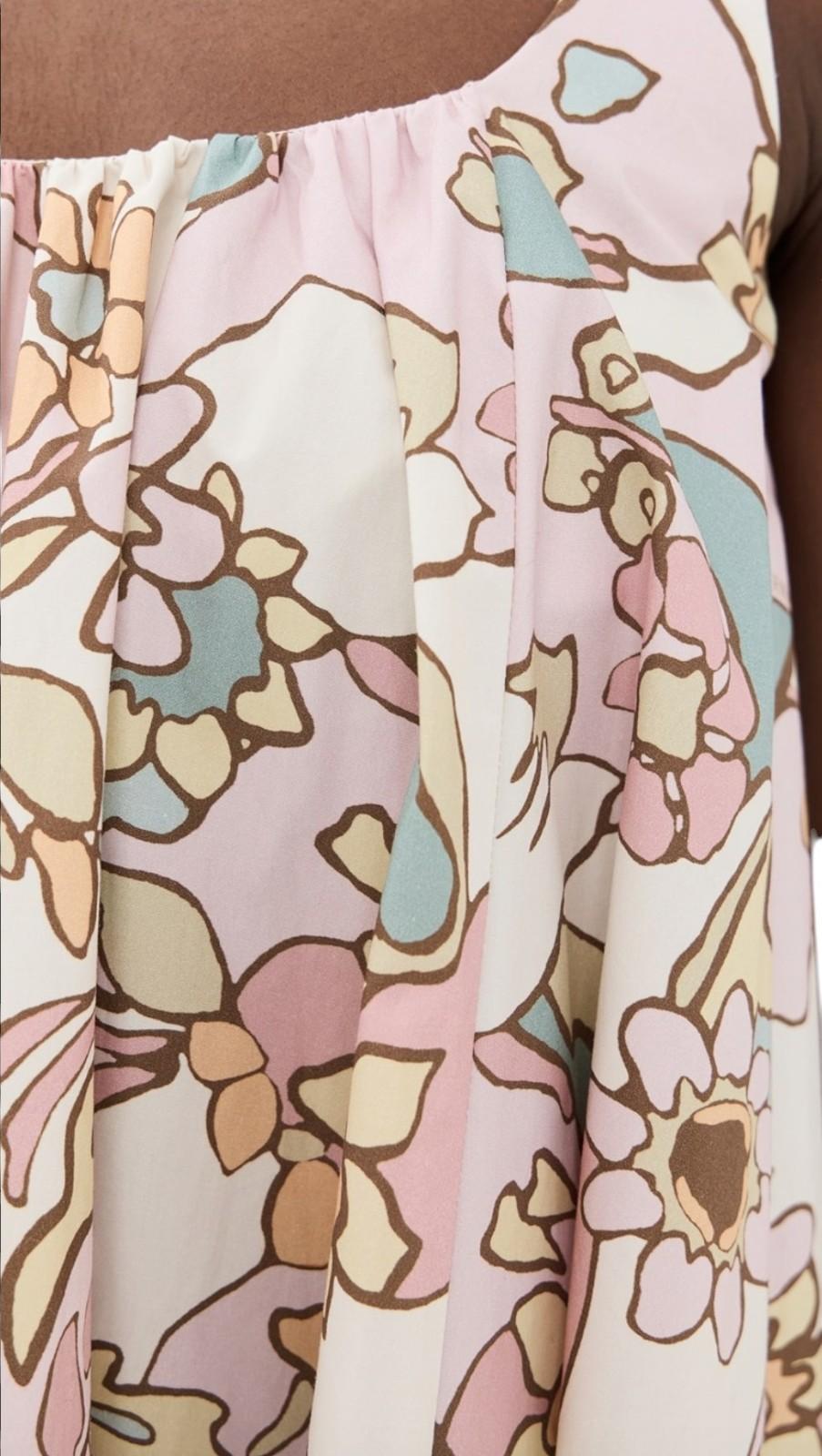 Close-up of a floral patterned fabric with pastel colors on a brown background