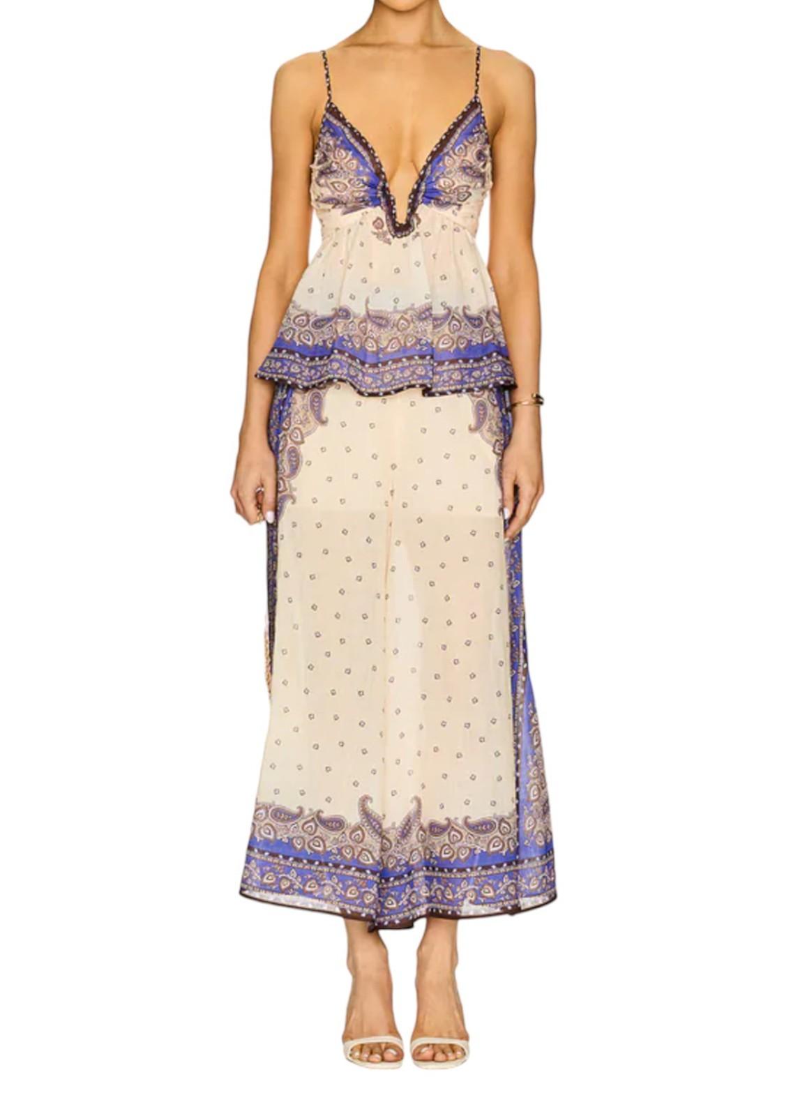 Woman wearing a patterned dress with a white background