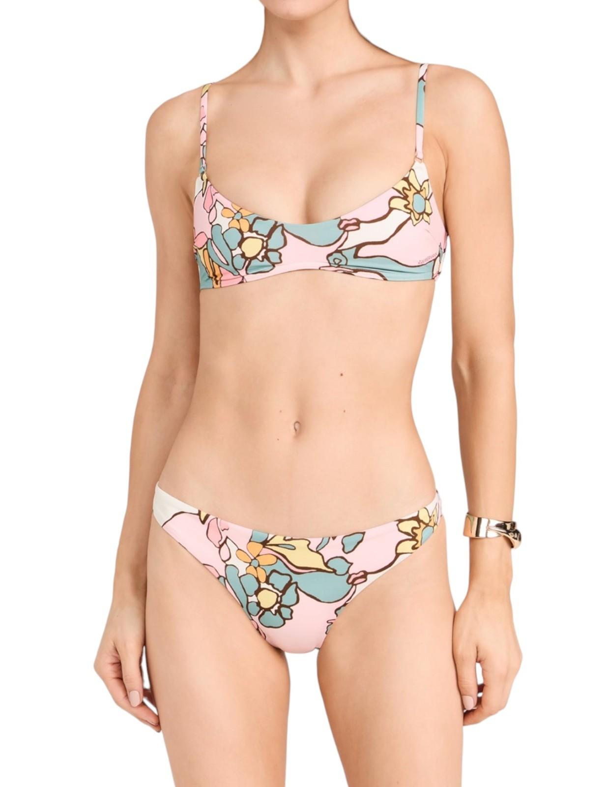 Woman wearing a colorful floral bikini on a white background