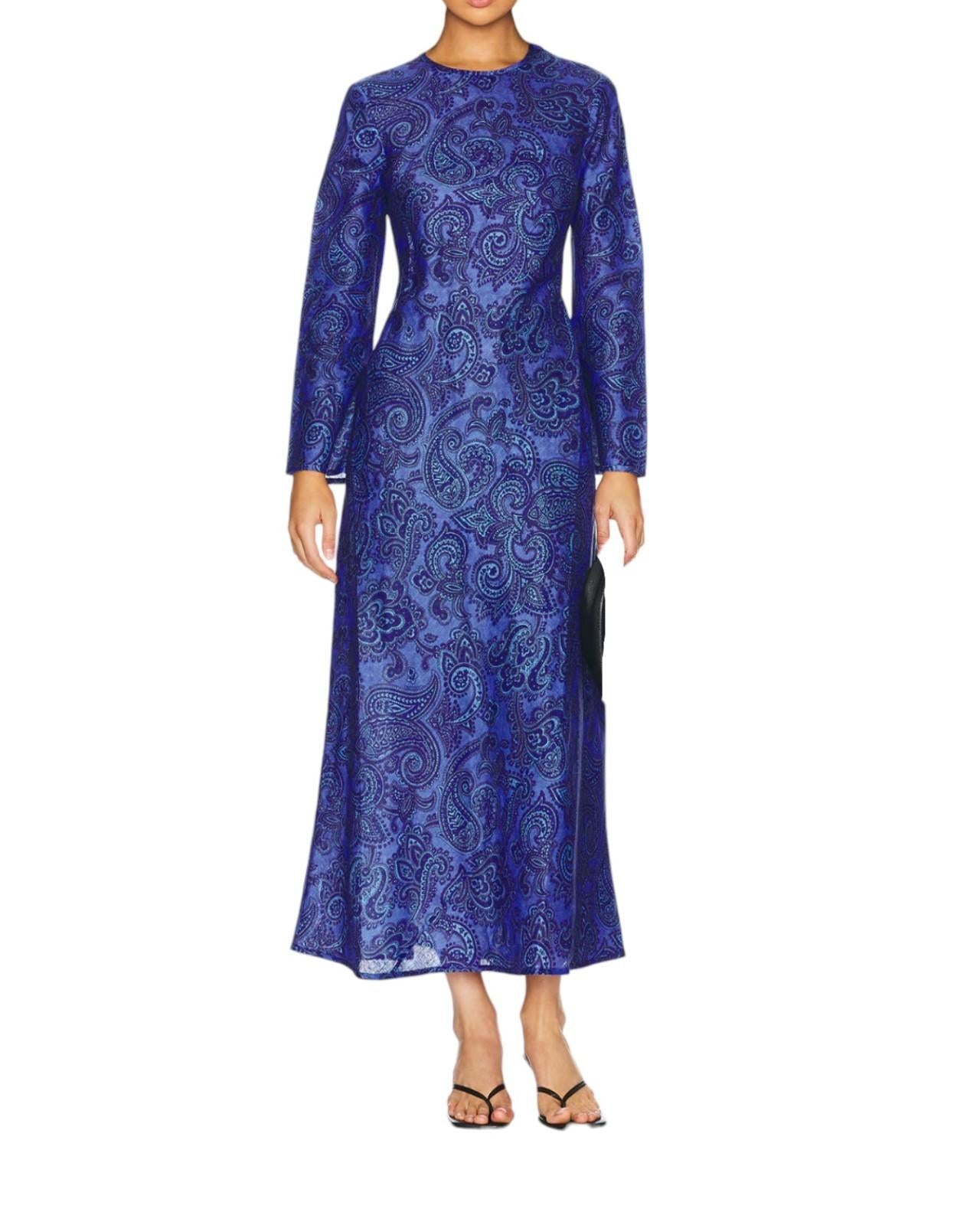 Woman wearing a blue patterned dress on a white background