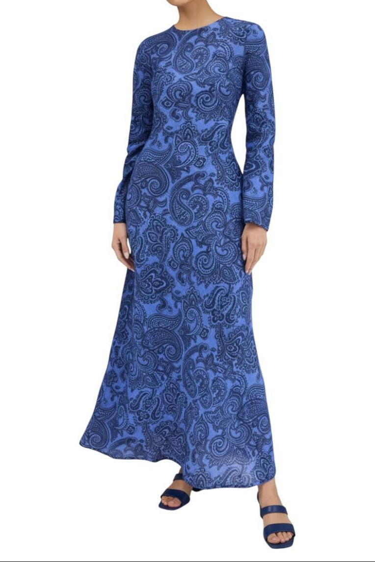 AI generated image of Woman wearing a blue patterned dress on a white background
