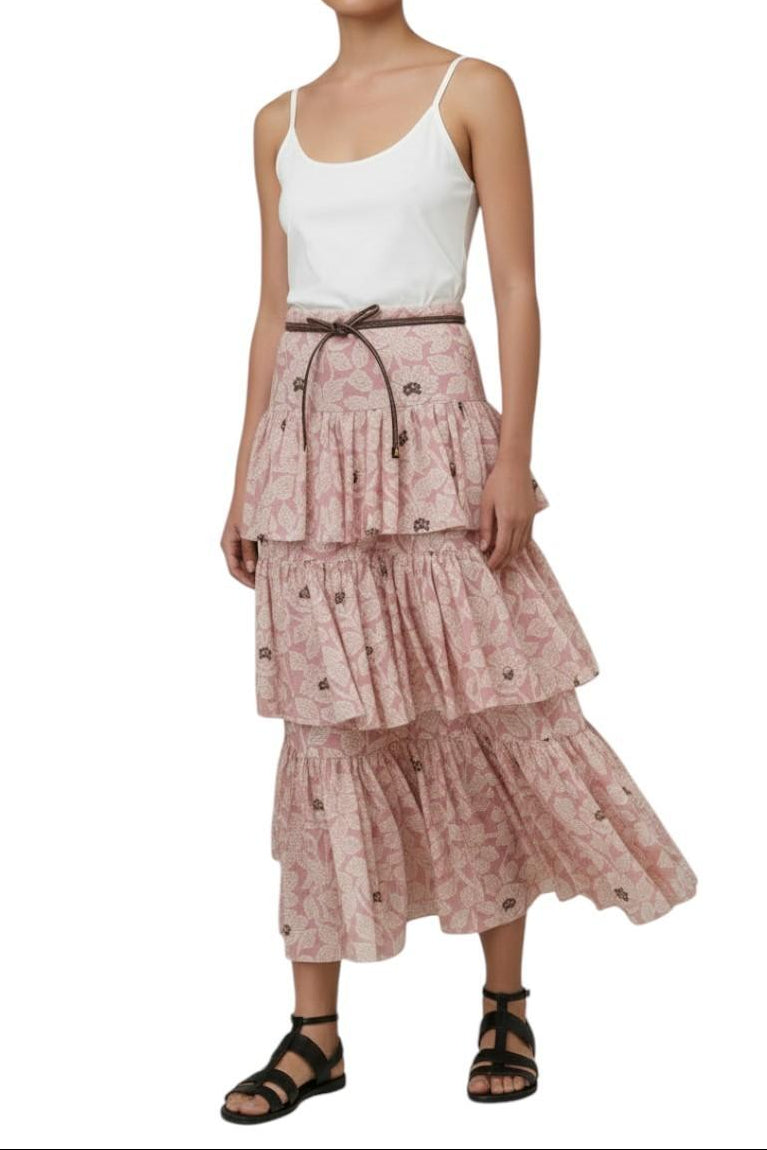 AI-generated image of Woman wearing a white tank top and a pink tiered skirt on a white background