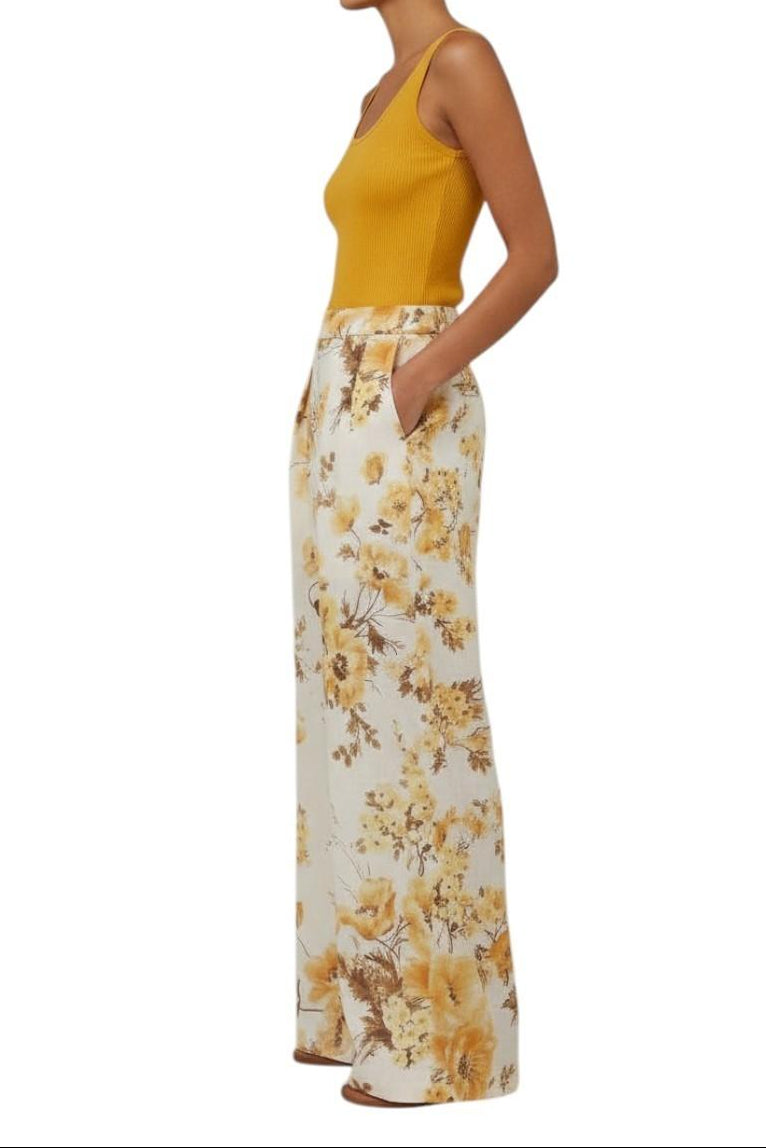 AI generated image of Woman wearing a yellow sleeveless top and floral pants on a white background