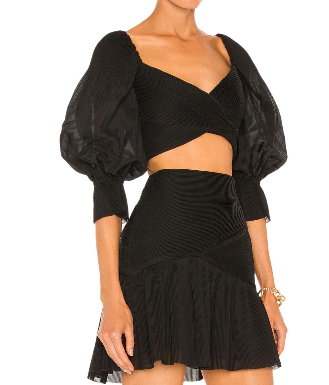 Black outfit with puffed sleeves and a skirt on a white background