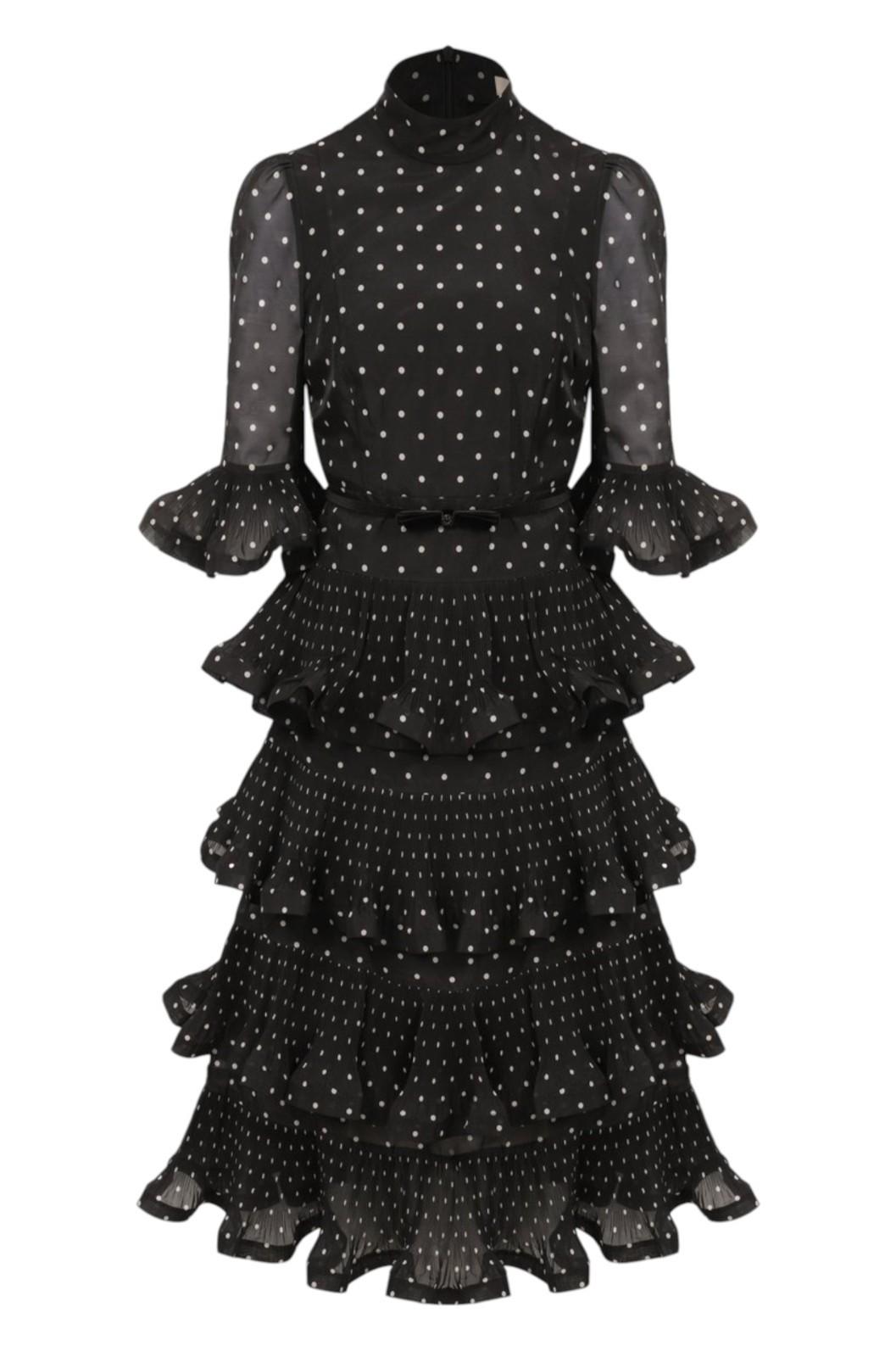 Black polka dot dress with ruffled layers on a white background