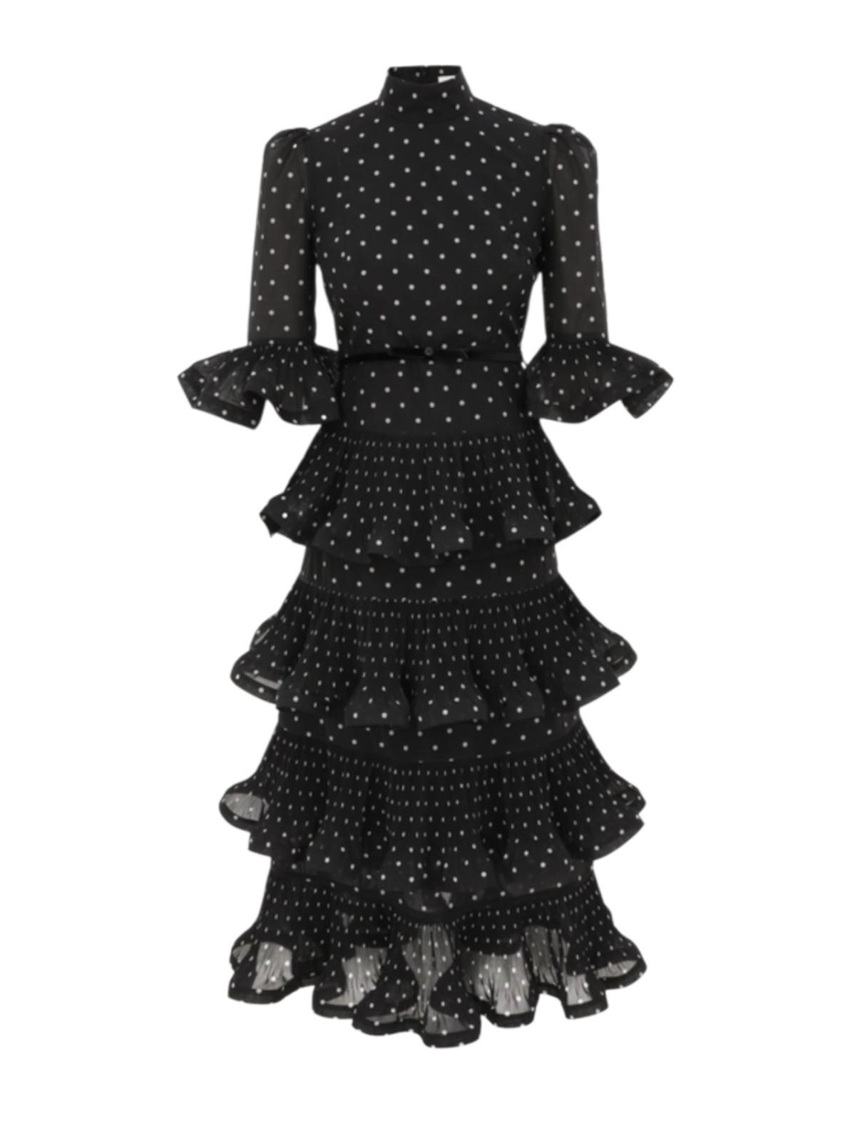 Black polka dot dress with ruffled layers on a white background