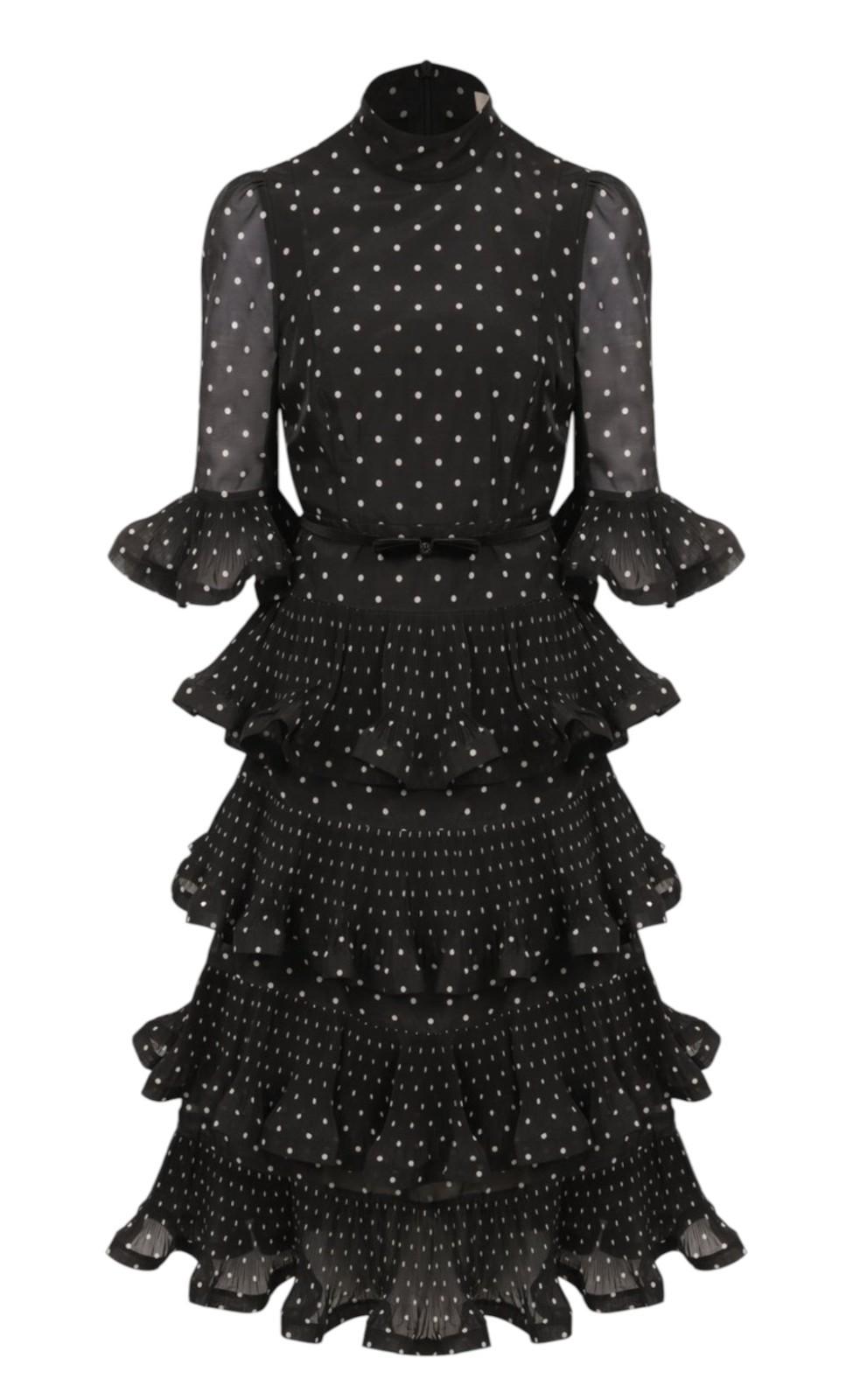 Black polka dot dress with ruffled layers on a white background