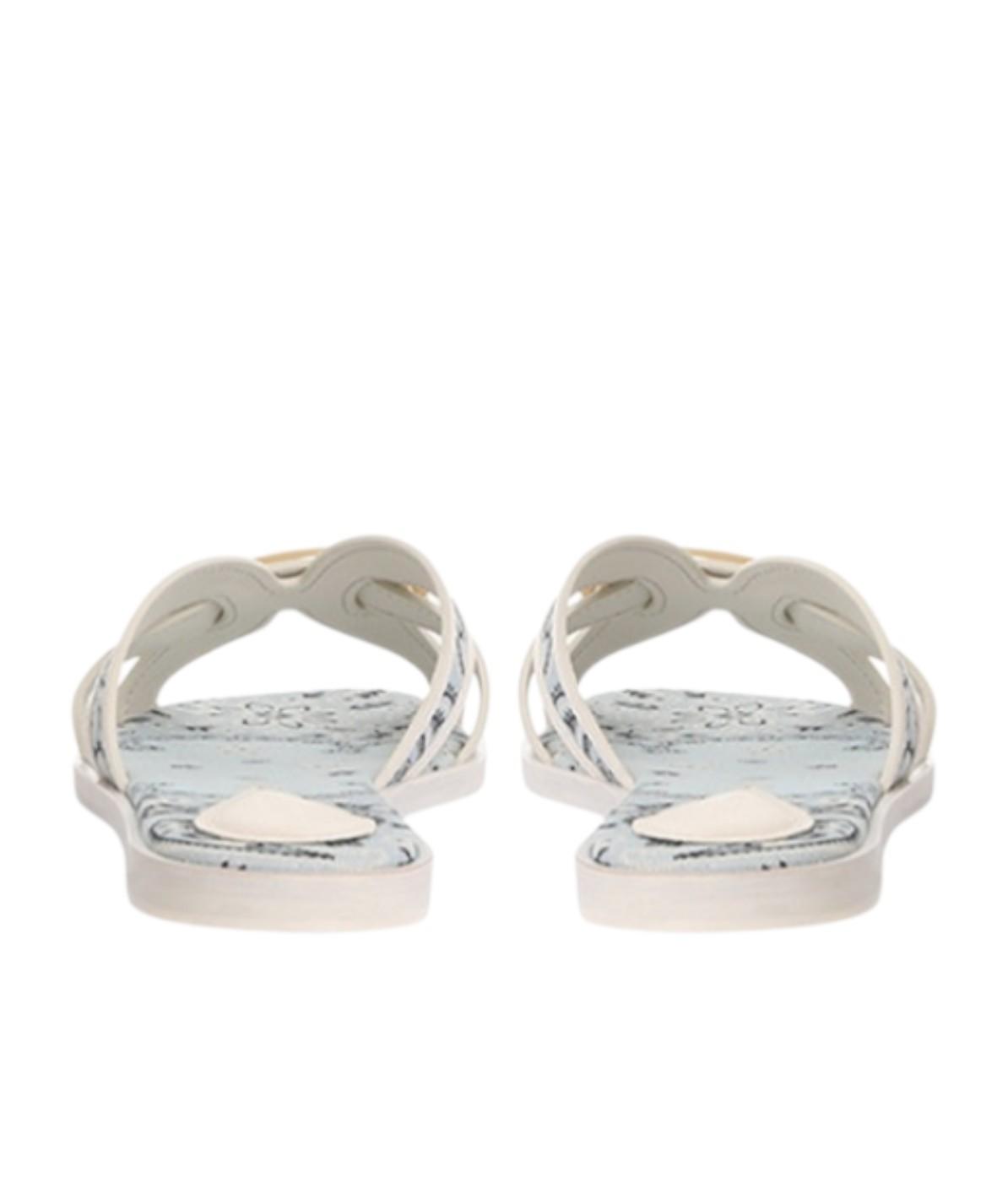 Pair of white sandals with marble pattern sole on a white background