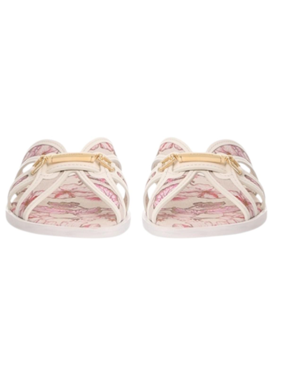 Pair of sandals with pink floral pattern on a white background