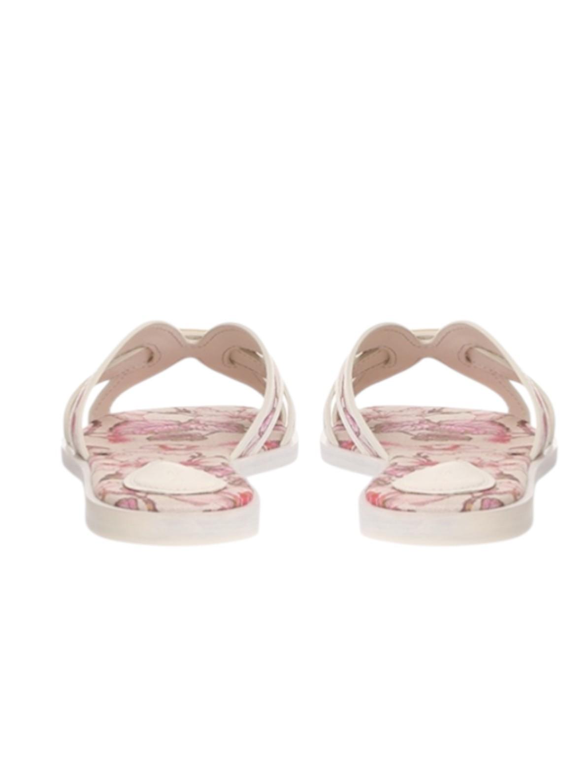 Pair of floral-patterned sandals on a white background