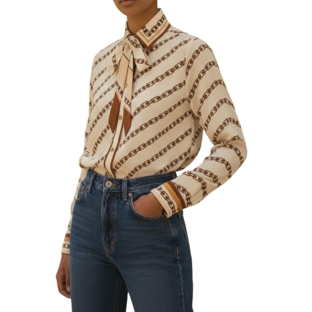 Person wearing a patterned blouse and jeans on a white background
