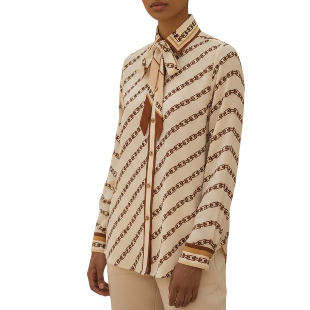 AI generated image of Beige patterned blouse worn by a model on a white background
