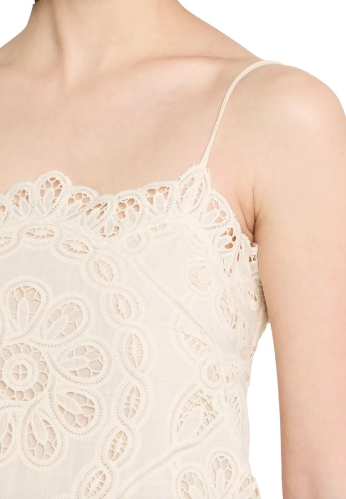 Close-up of a beige lace camisole with thin straps on a white background