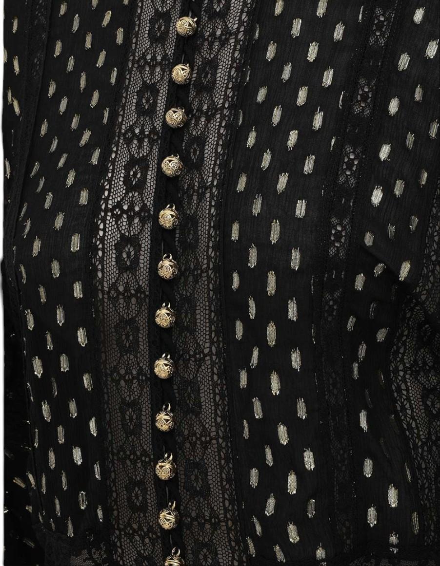Black lace garment with gold buttons on a white background