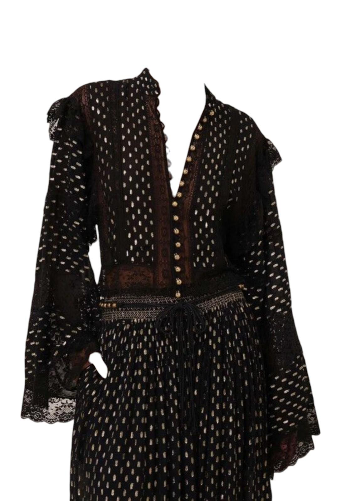 Black patterned dress with a fitted bodice and long sleeves on a white background