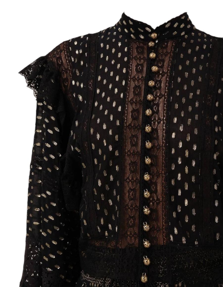 Black embroidered blouse with gold details on a white background