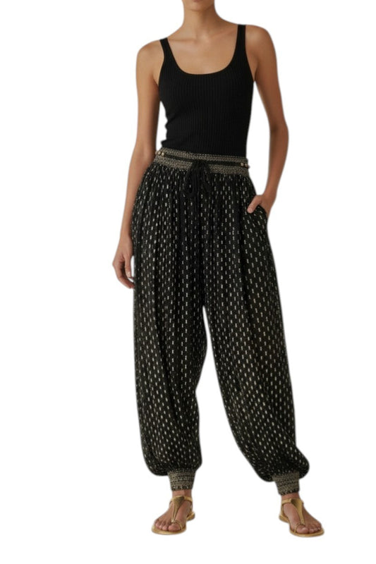 AI generated image of Woman wearing a black tank top and patterned black and white pants on a white background