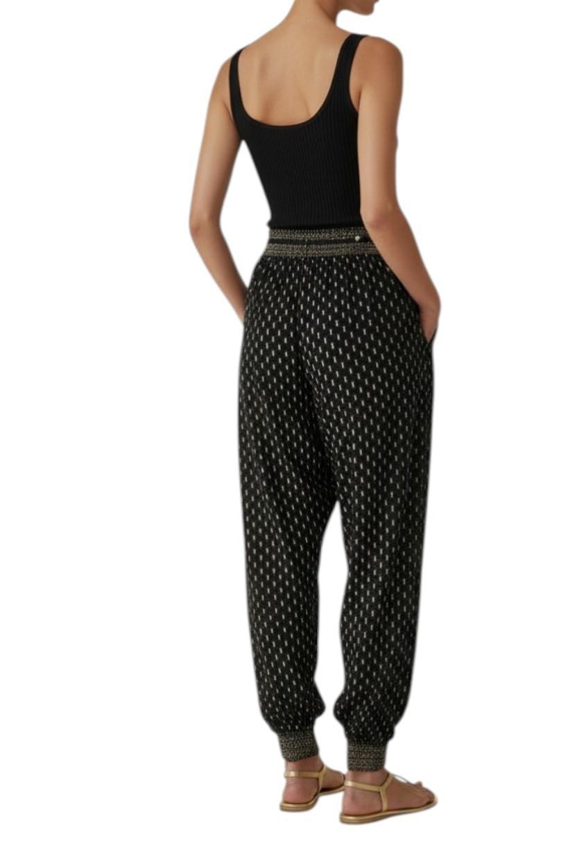 AI generated image of Person wearing a black tank top and patterned pants on a white background
