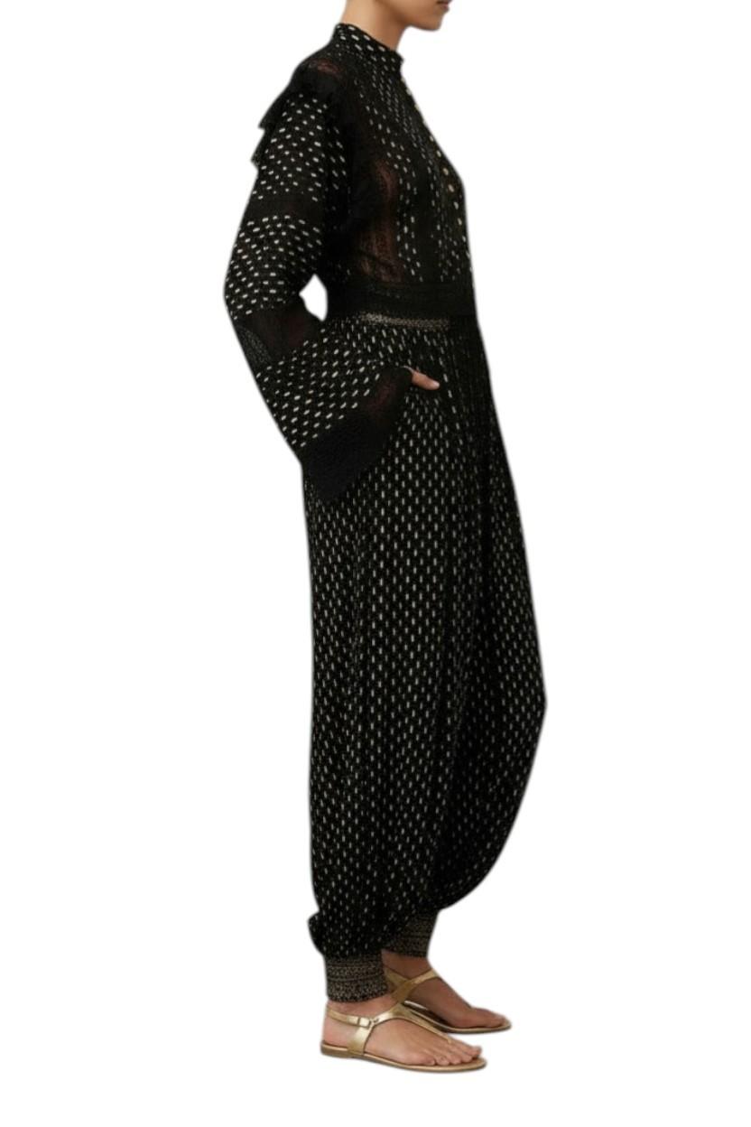 Black polka dot dress with sheer overlay on a white background