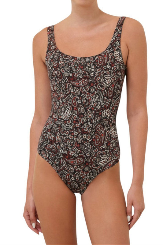 Woman wearing a patterned one-piece swimsuit on a white background