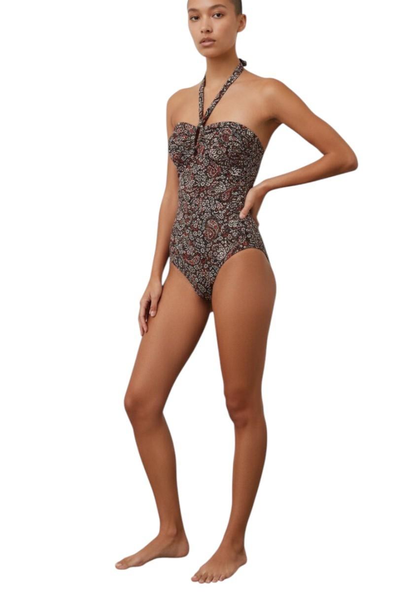 Woman wearing a floral one-piece swimsuit on a white background