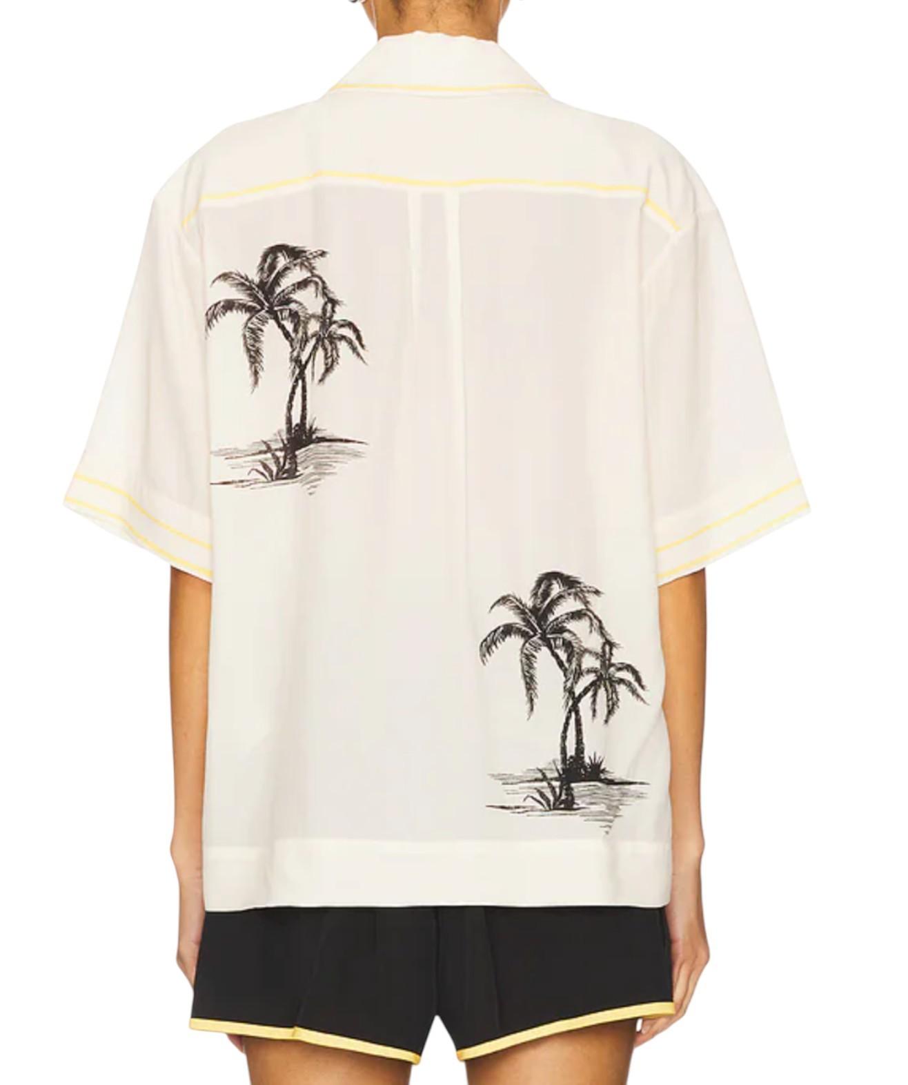 White shirt with palm tree designs on a white background