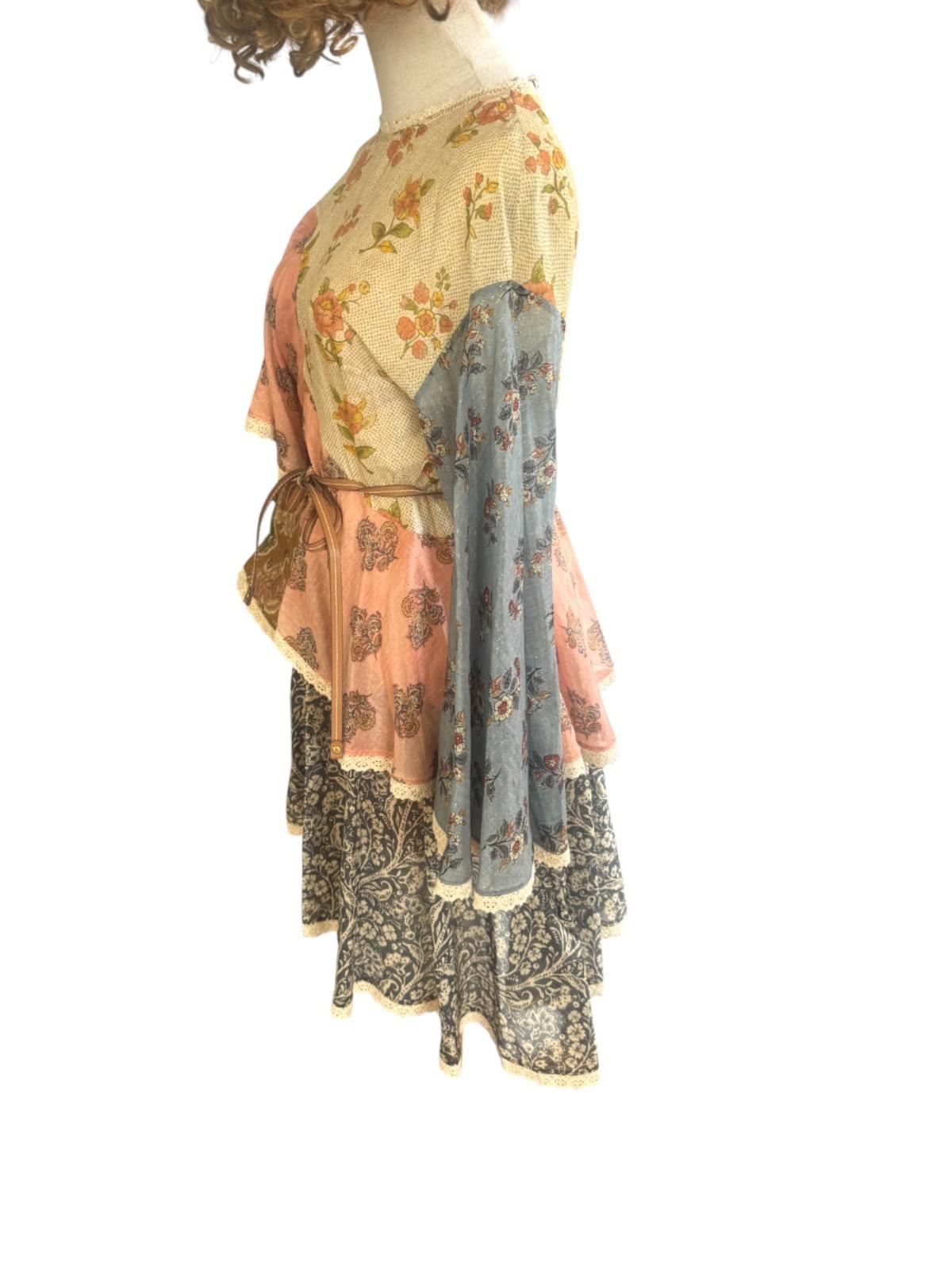 Mannequin wearing a floral dress with a sheer overlay on a white background