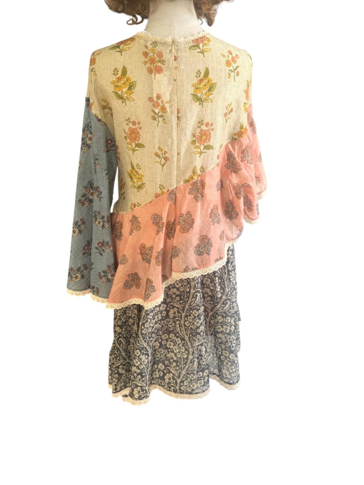 Mannequin wearing a floral and patterned dress with a white background