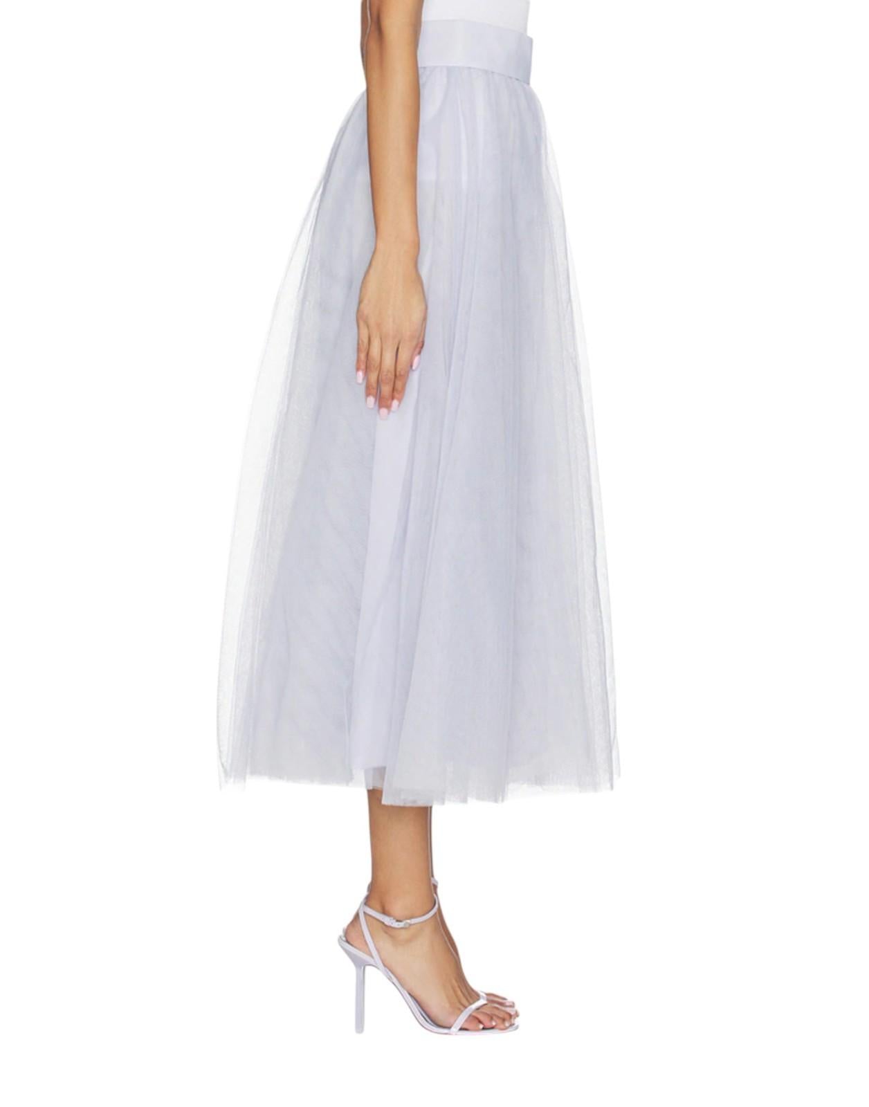 White tulle skirt worn by a person on a white background