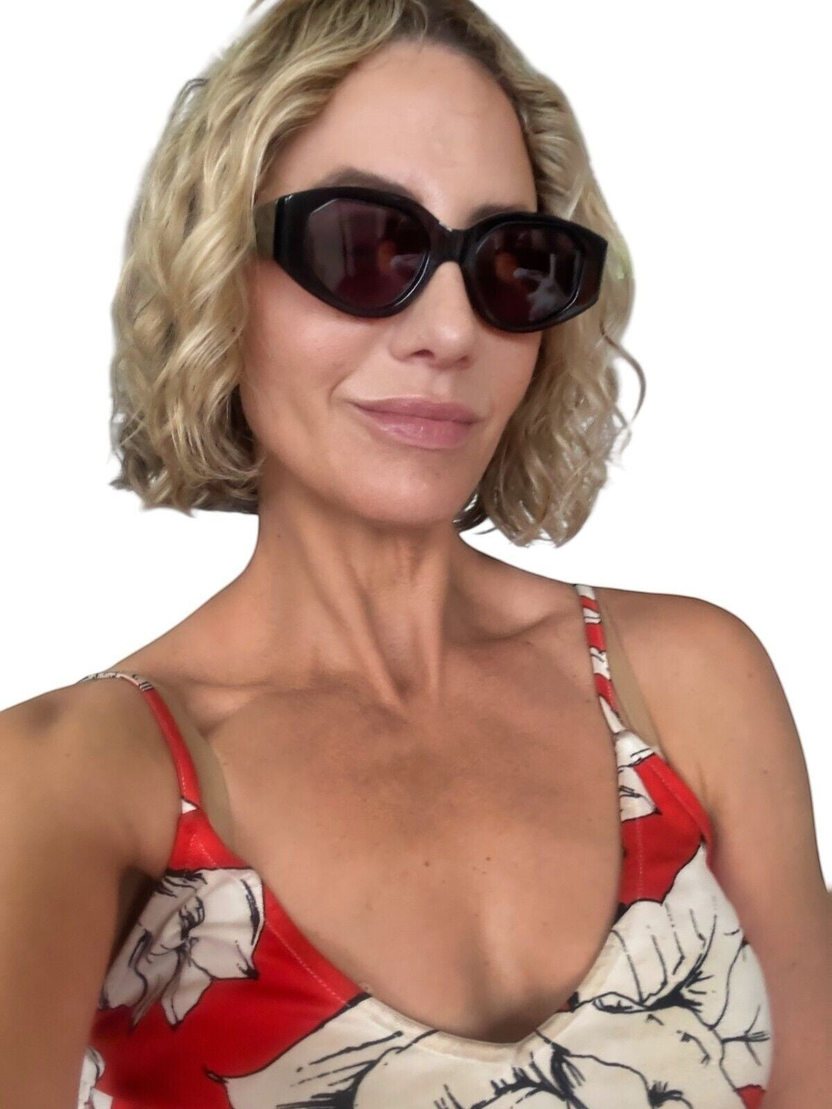 A woman wearing Naked Pear Karen Walker Castaway black oval acetate sunglasses with grey smoke lenses.