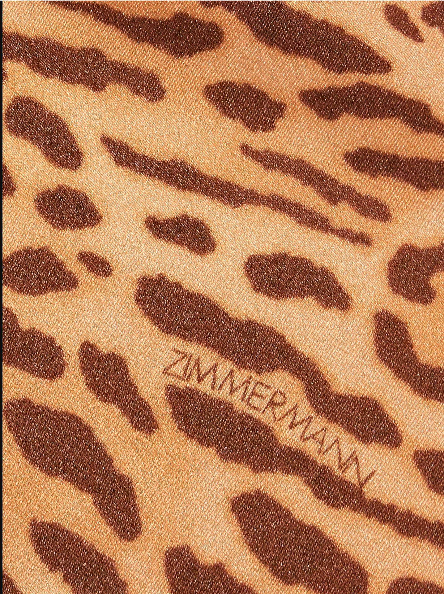 Leopard print fabric with 'Zimmermann' branding on a beige background