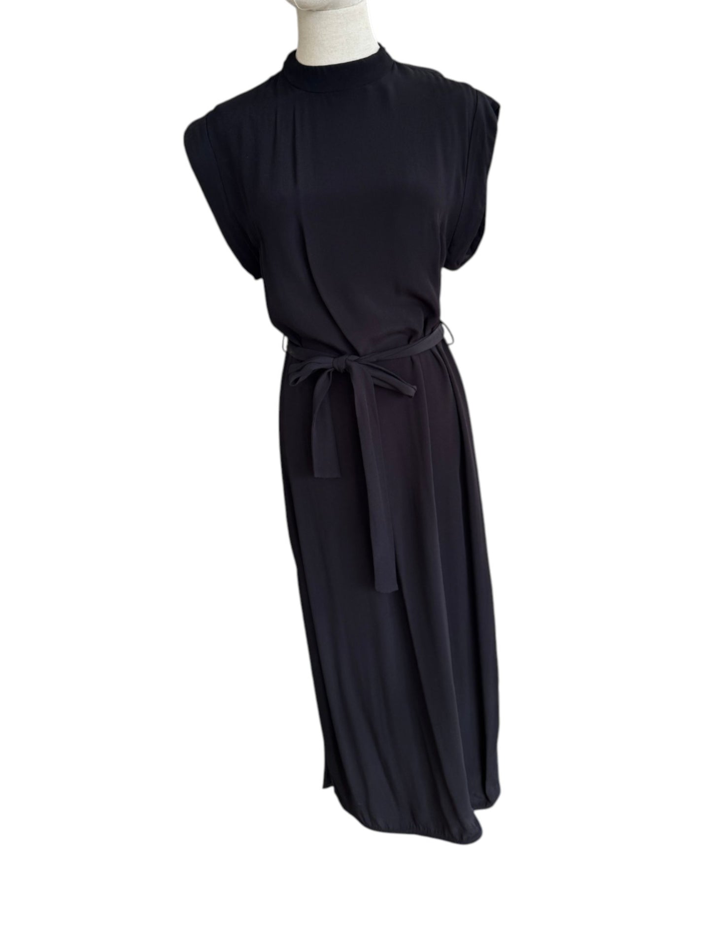 Black dress on a mannequin against a white background