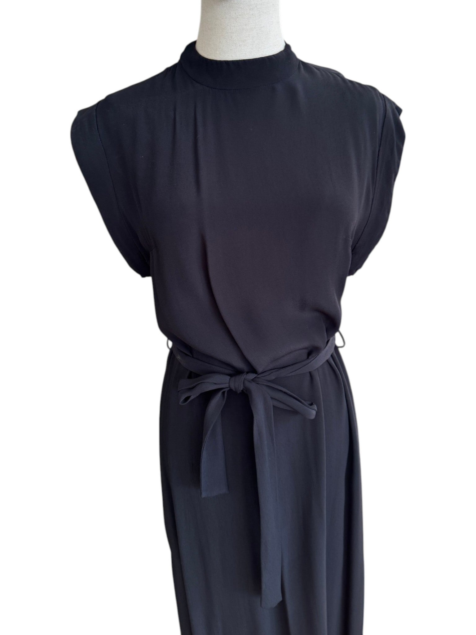 Dark blue sleeveless dress with a tie waist on a mannequin against a white background