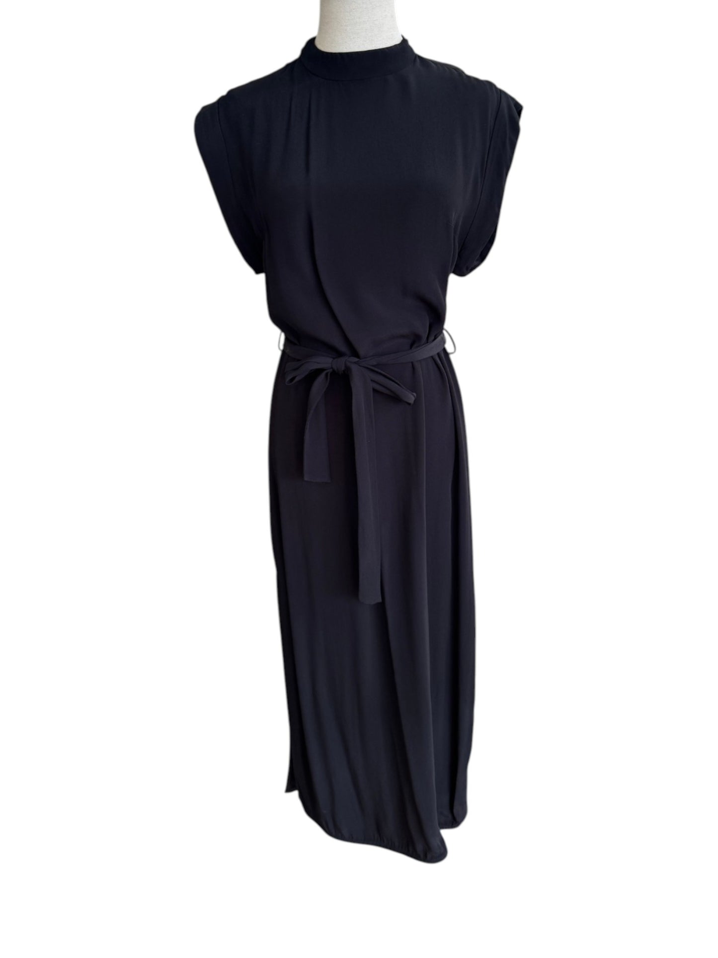 Black sleeveless dress on a mannequin against a white background