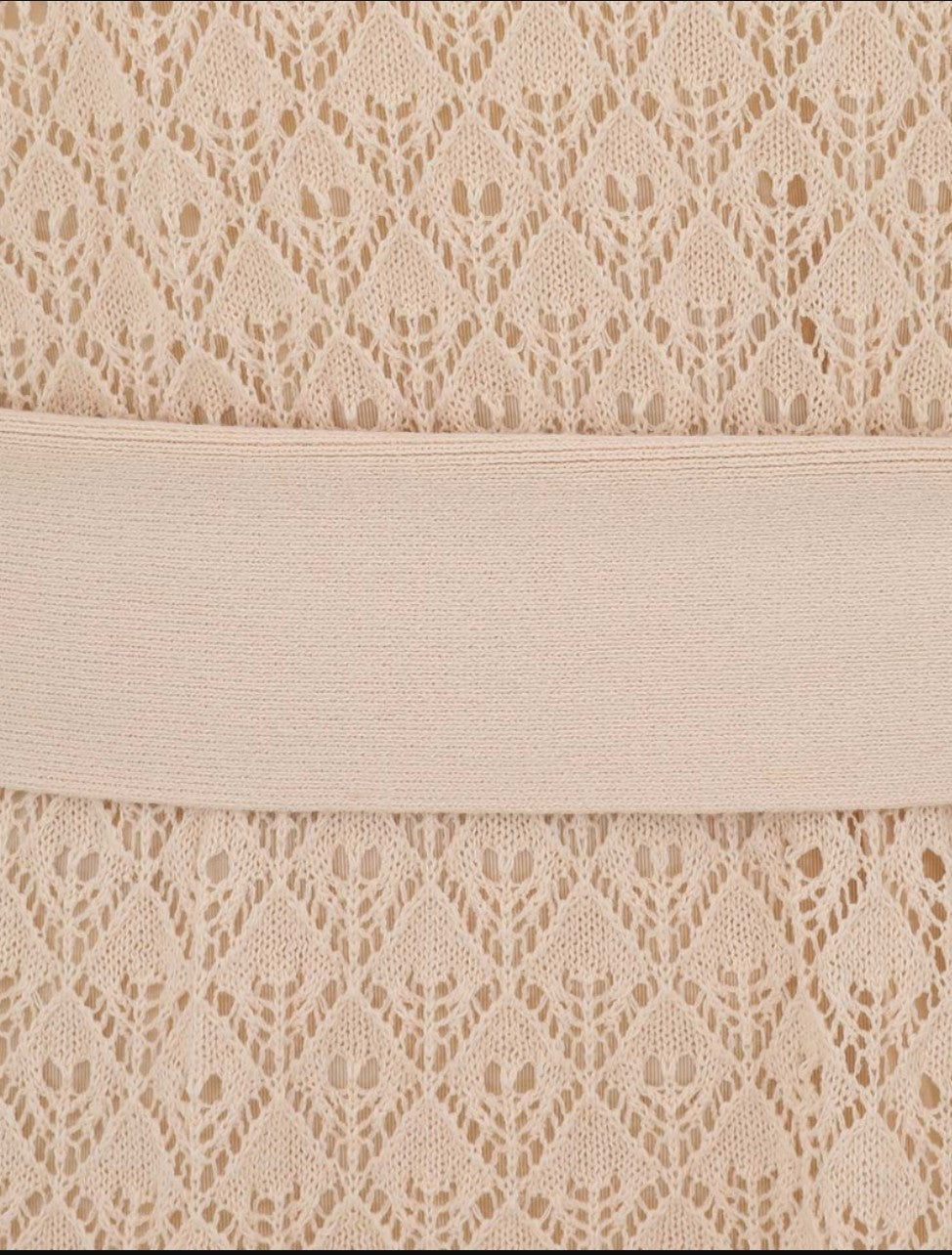 Close-up of the cream pointelle knit fabric and waist belt on a Naked Pear Zimmermann Crush midi dress.