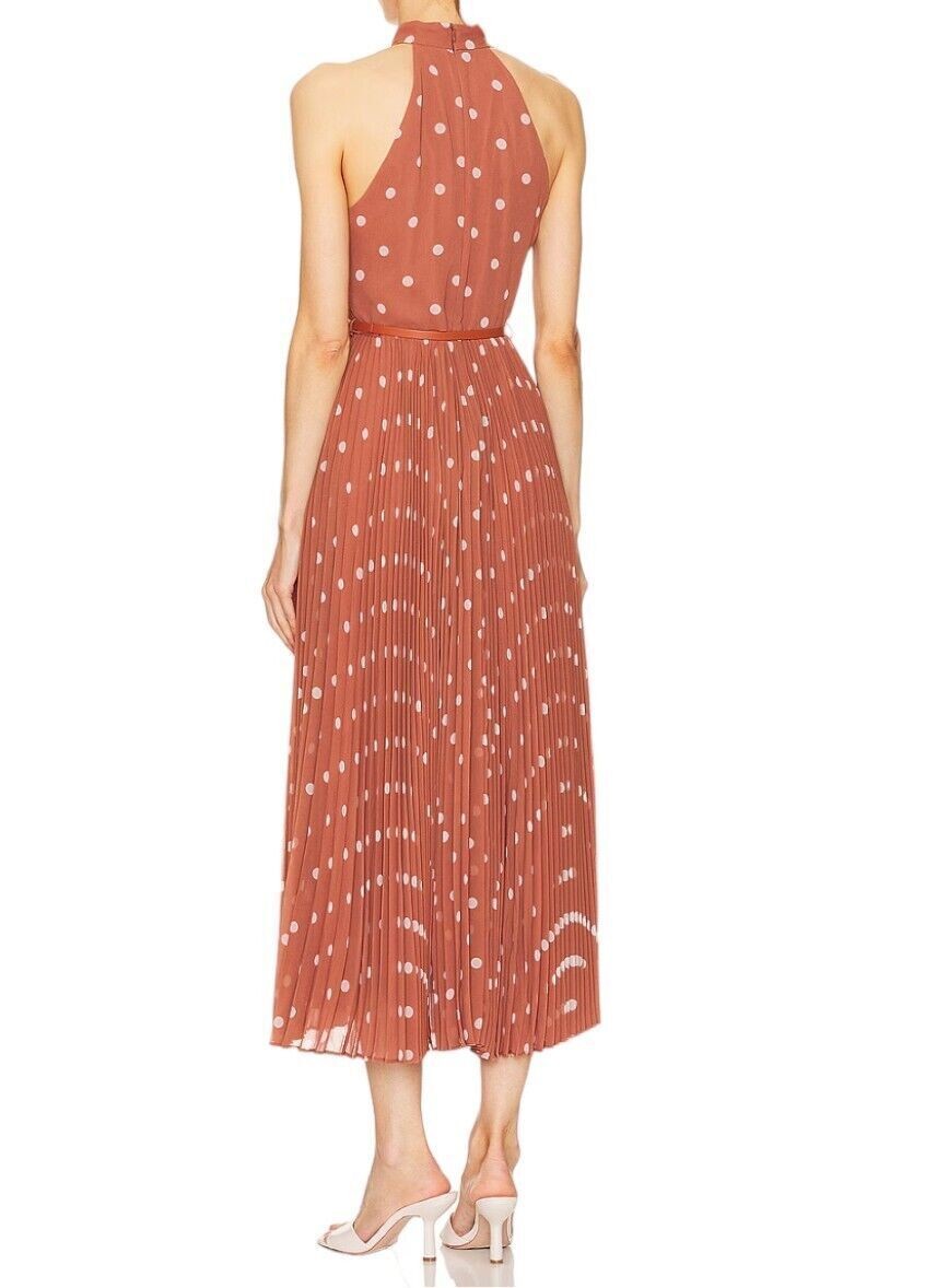 Back view of a Zimmermann Sunray Picnic dress in aragon cream polka dot with a leather tie belt, sold by Naked Pear.