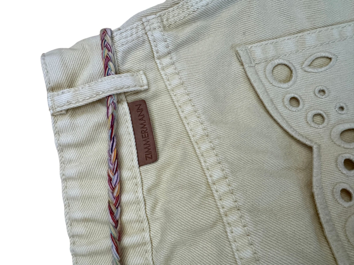 Naked Pear Zimmermann yellow cotton denim mini skirt featuring a leather logo tag, braided belt, and scalloped hem.
